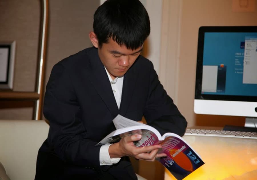 Ding Liren with Chess Informant 121